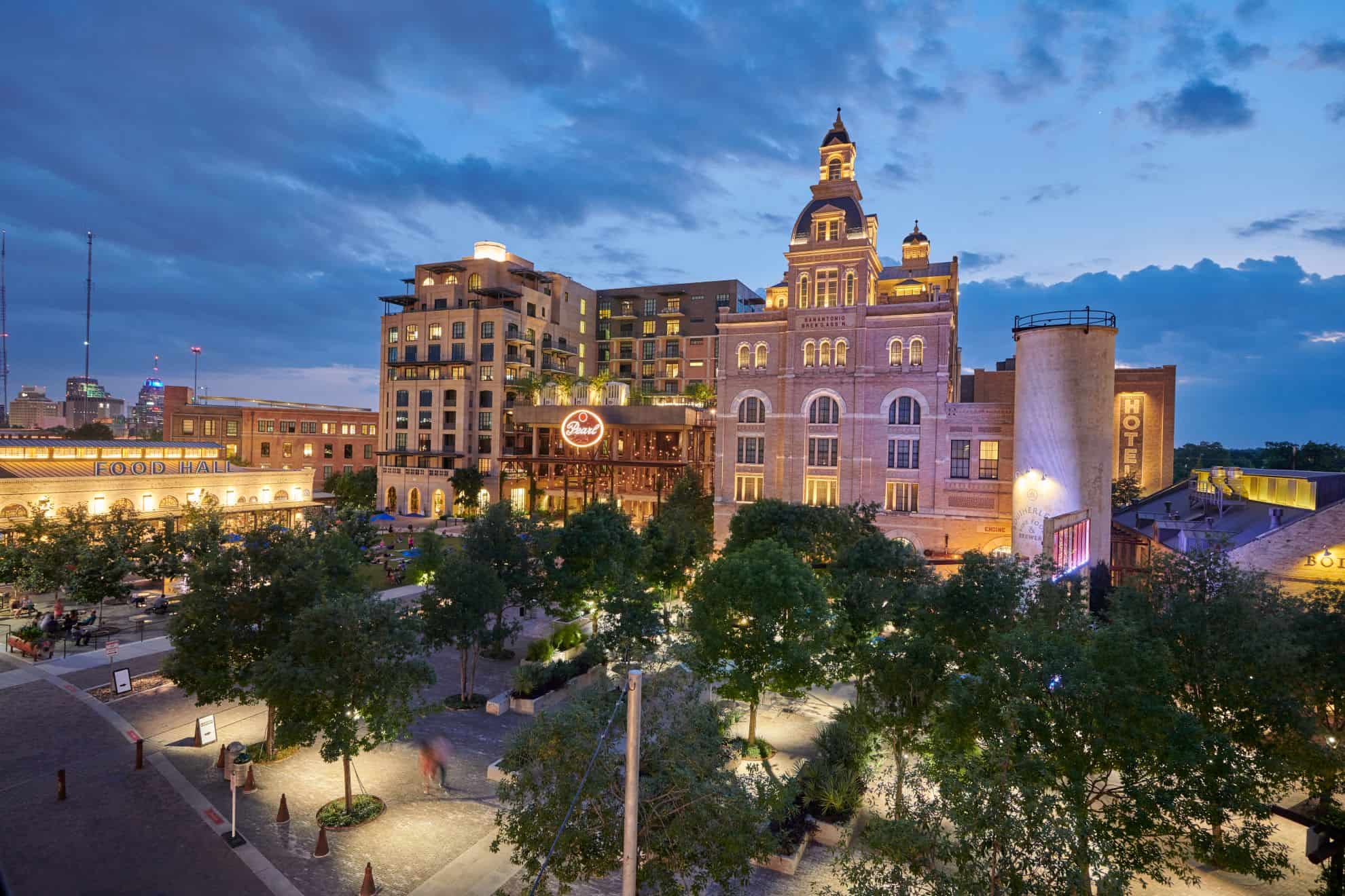 Night view of the Brewery District with illuminated buildings and vibrant public spaces