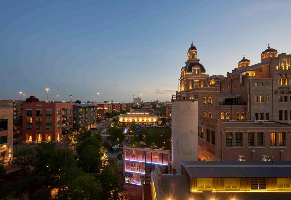 Urban district nightscape with illuminated historic buildings and vibrant streetscape