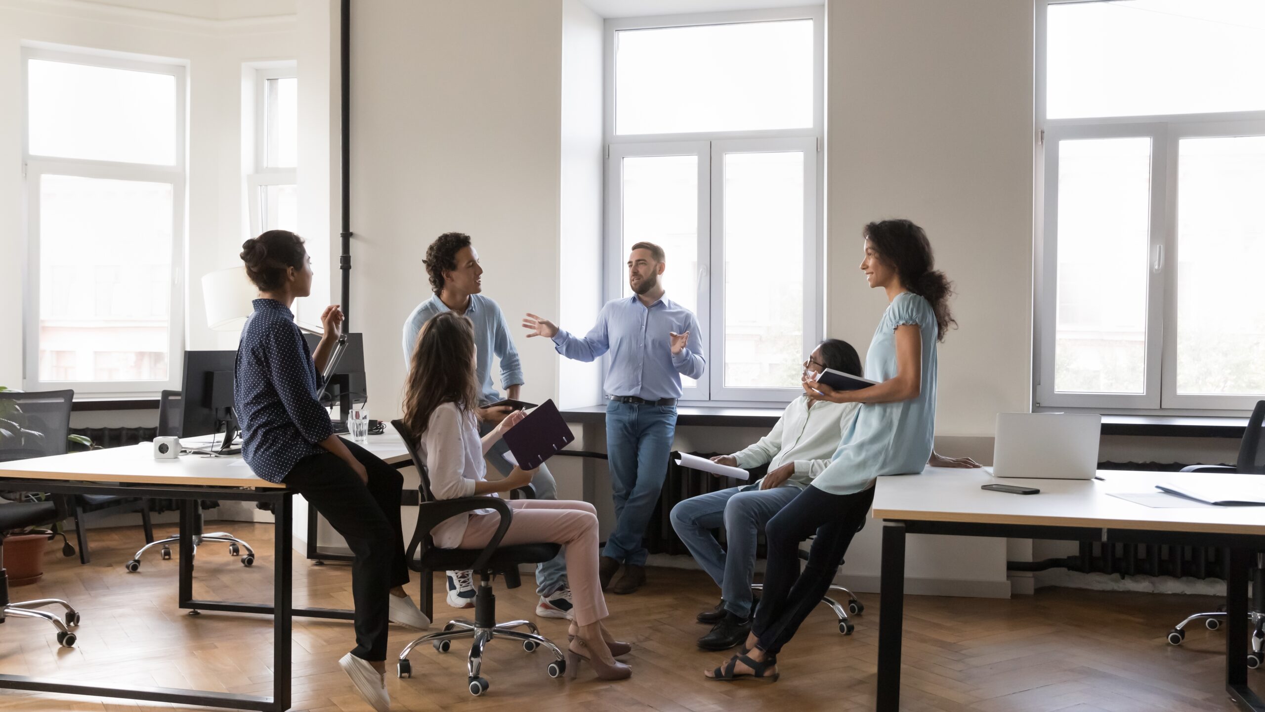 Team discussing a community engagement plan in a modern office setting.